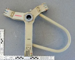 Seized launcher part on a forensic scale