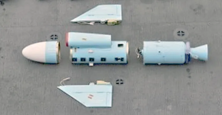 Seized missile parts laid out: nose cone, air intake, booster, fins