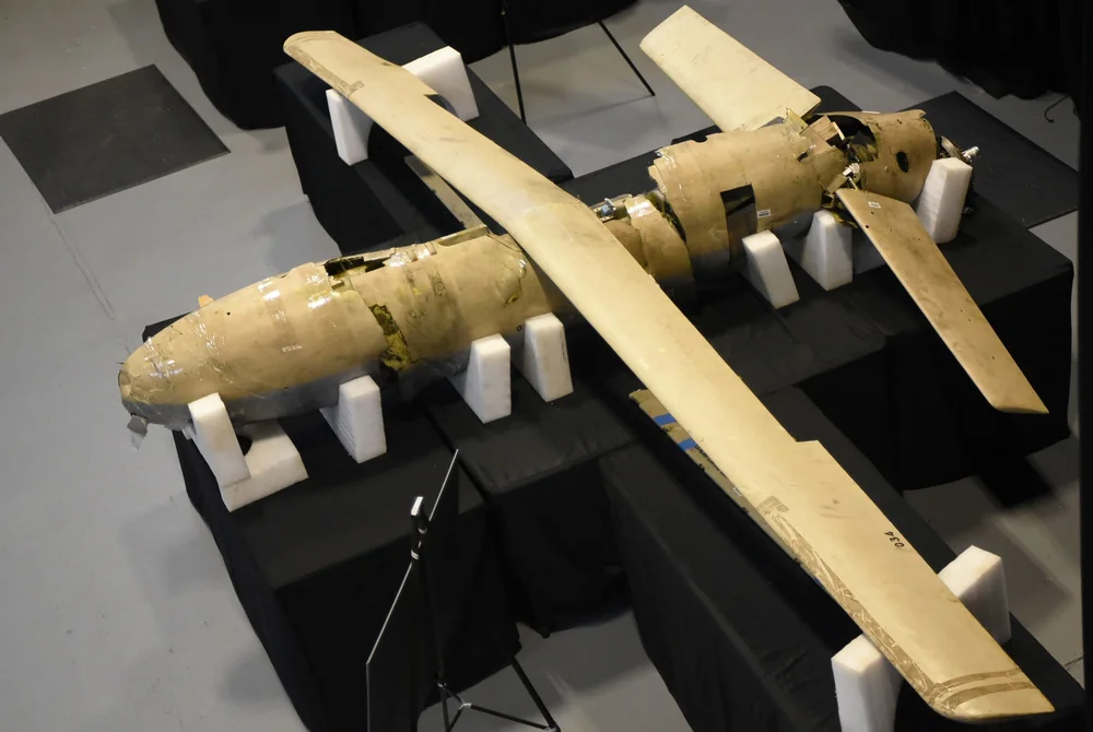 Remains of a Shahed-123 drone on white foam blocks at a display table
